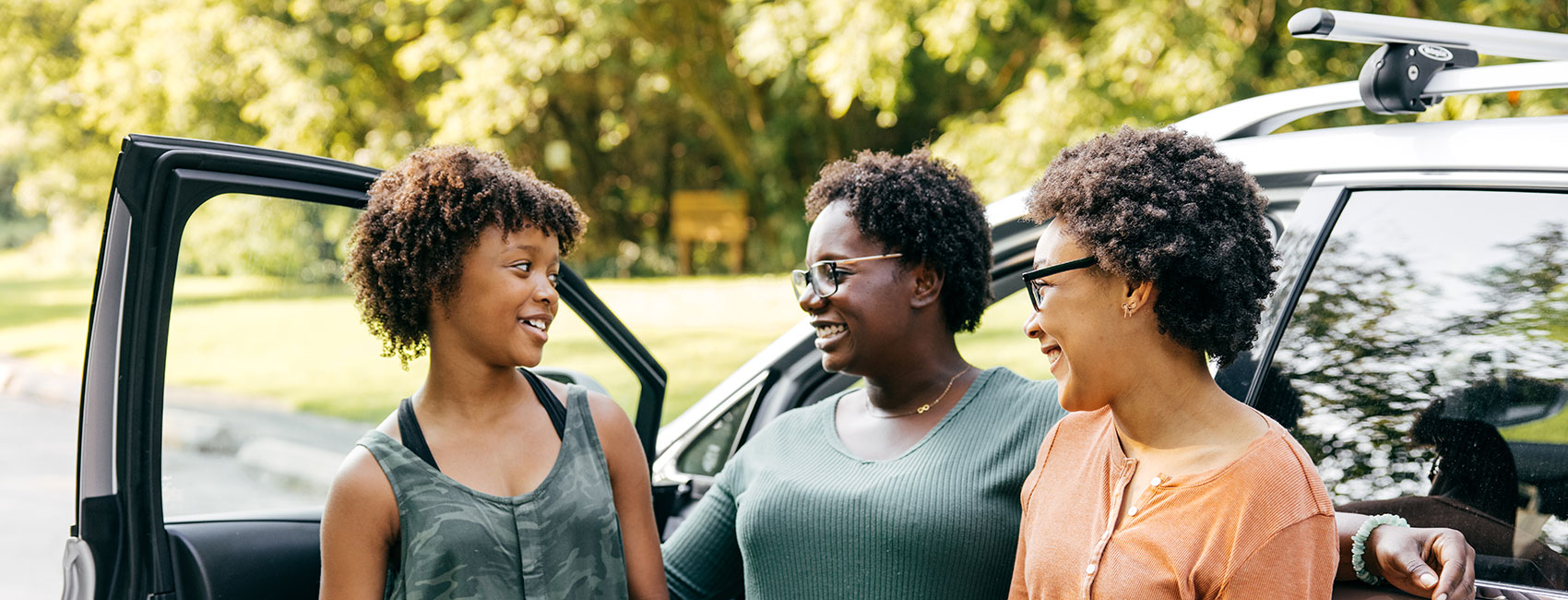 mom wishing farewell to her two daughters on their first day back to school