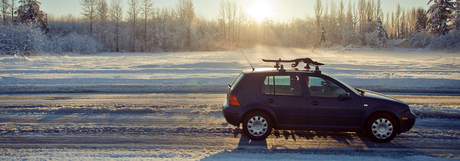 car driving on snowy winter road