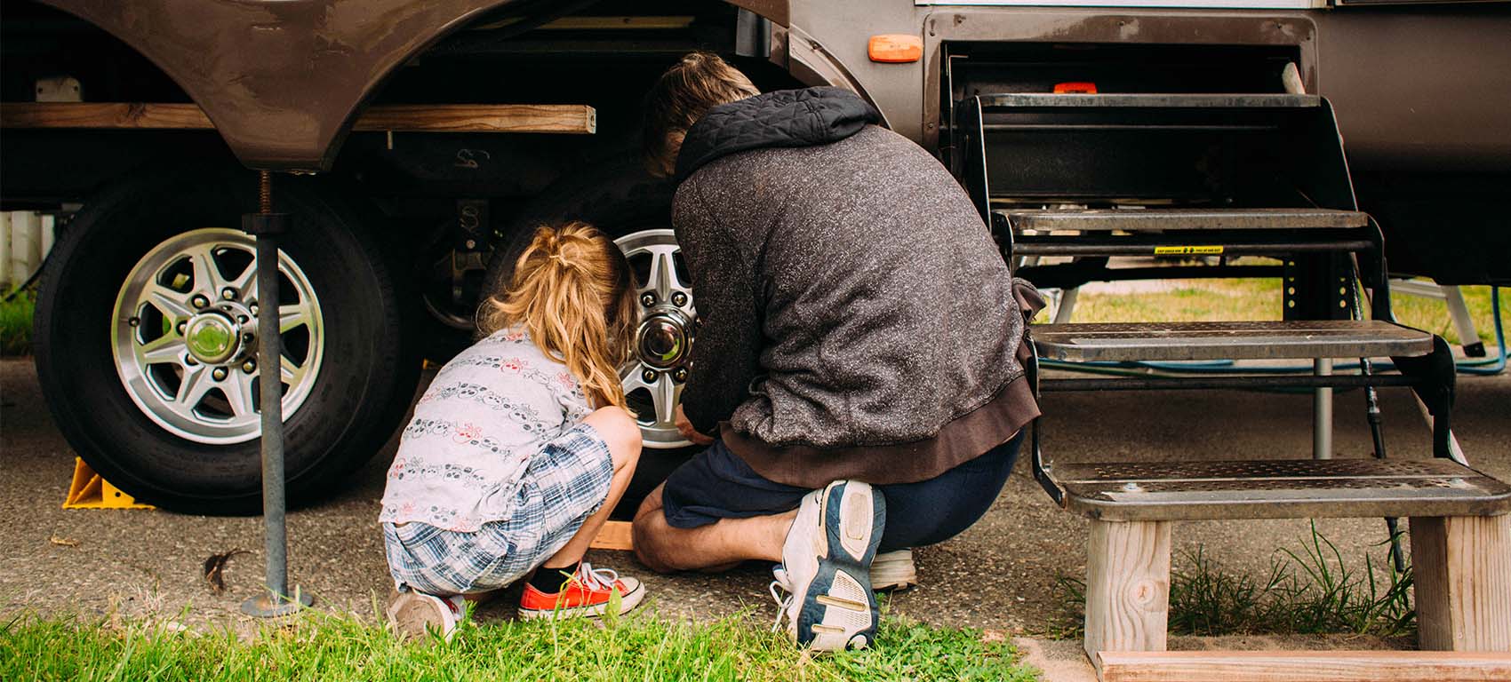 father and daughter fixing tire