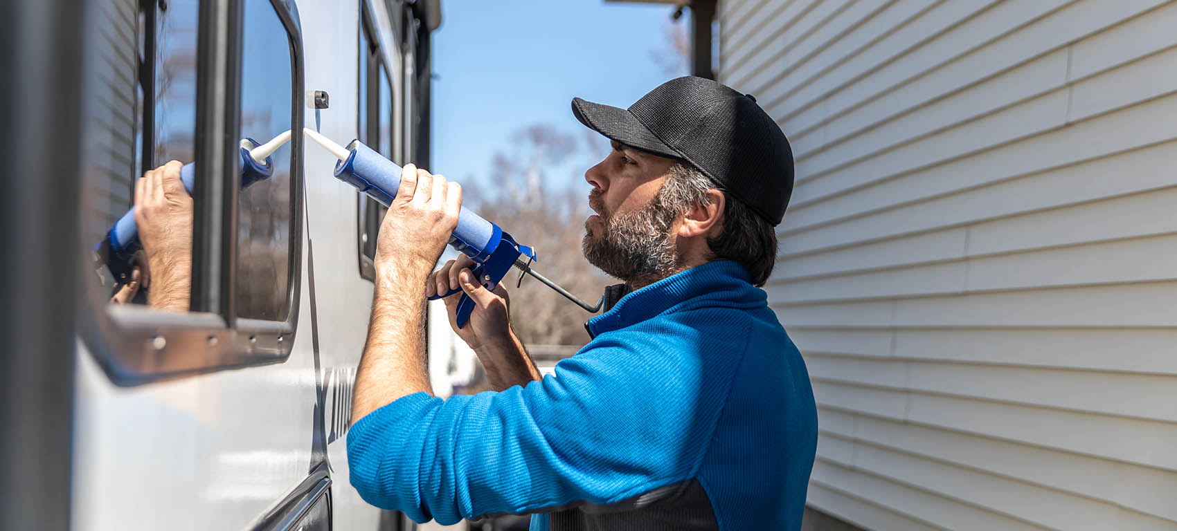 man doing maintenance of camper trailer