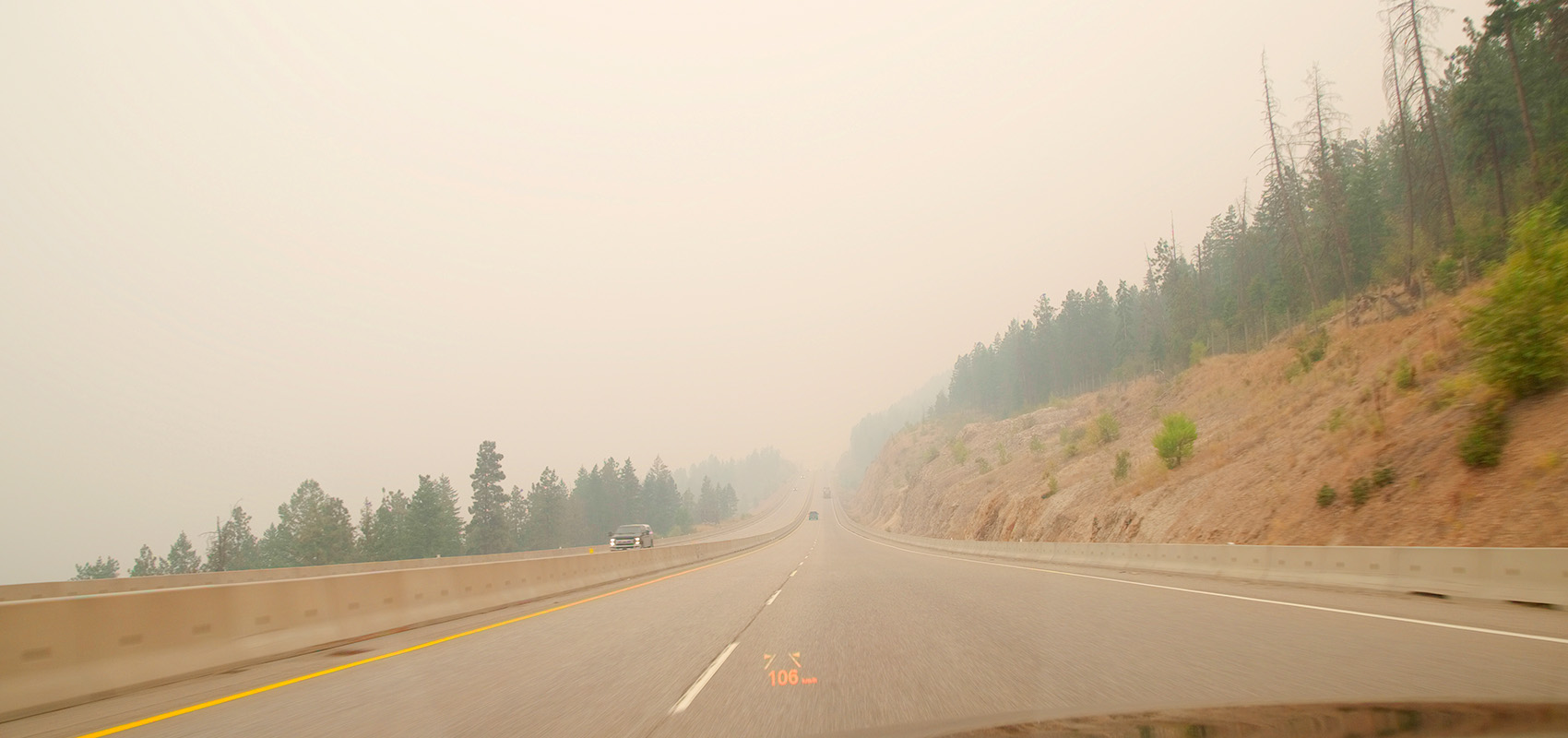 View down highway with smoky skies