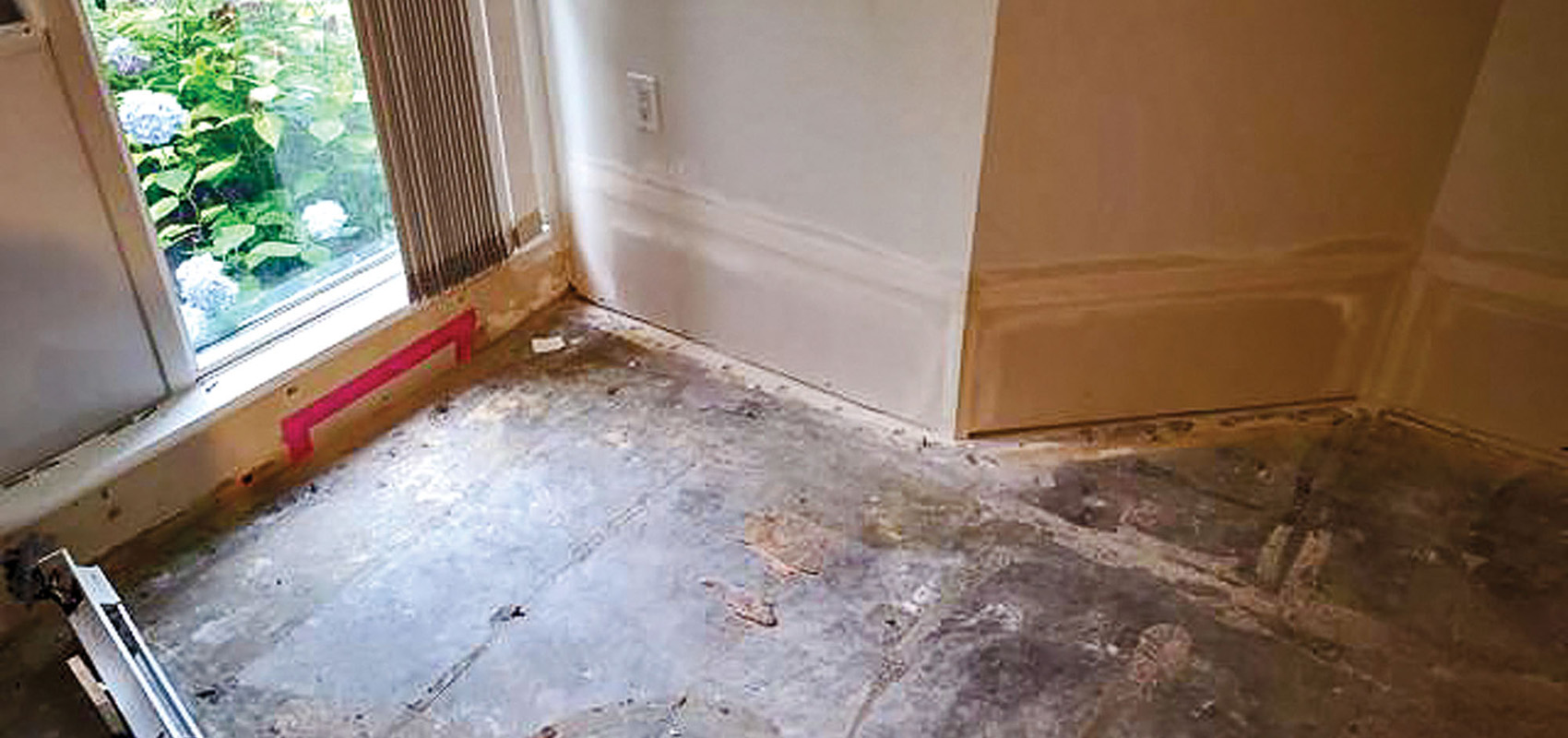 Water-damaged floor removed revealing subfloor