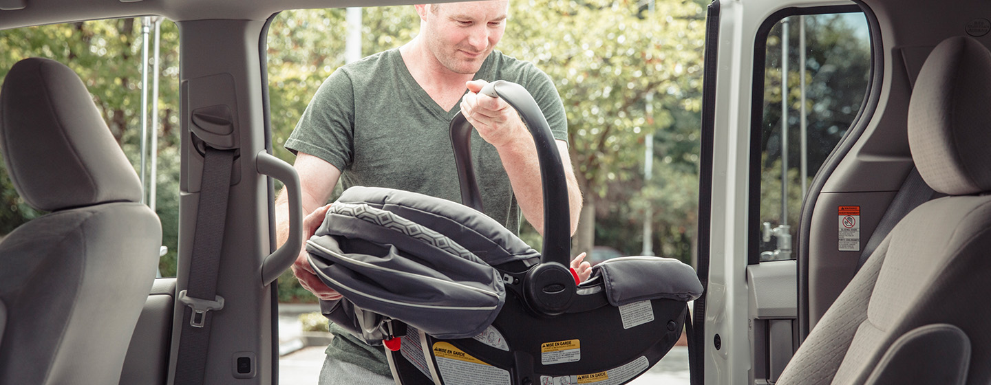 man installing car seat