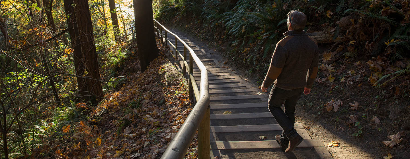 man walking on trail