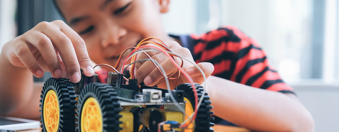 boy playing with mechanical toy car