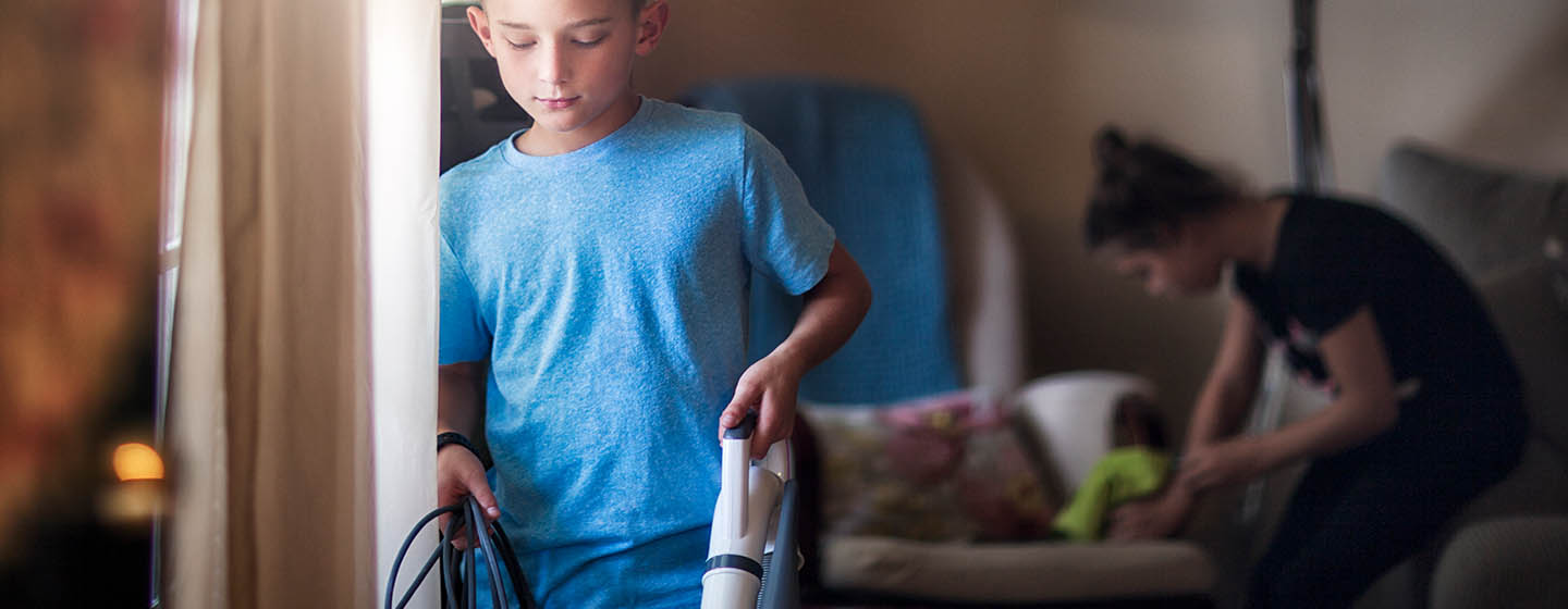 boy vacuuming at home