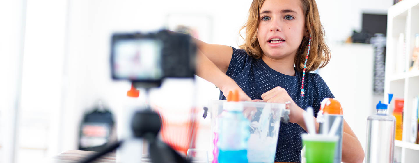 girl recording herself making craft at home