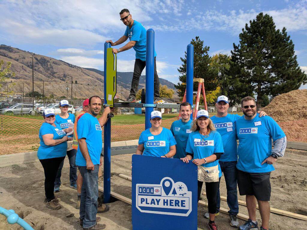 BCAA volunteers pose for a picture on a playground under construction