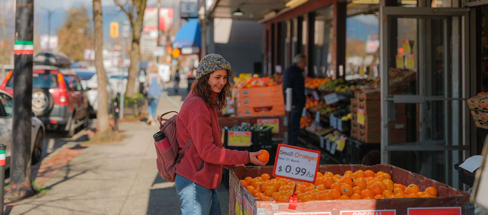 Woman buying oranges in produce shop