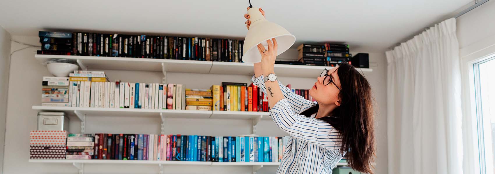 Woman changing bulb in her house 