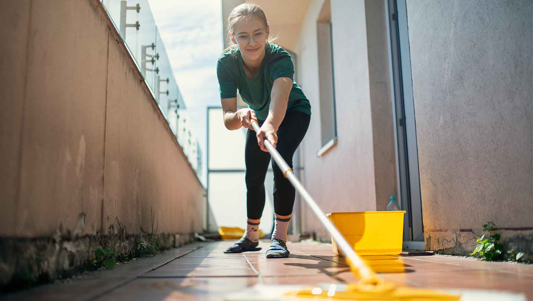 cleaning the balcony with a mop