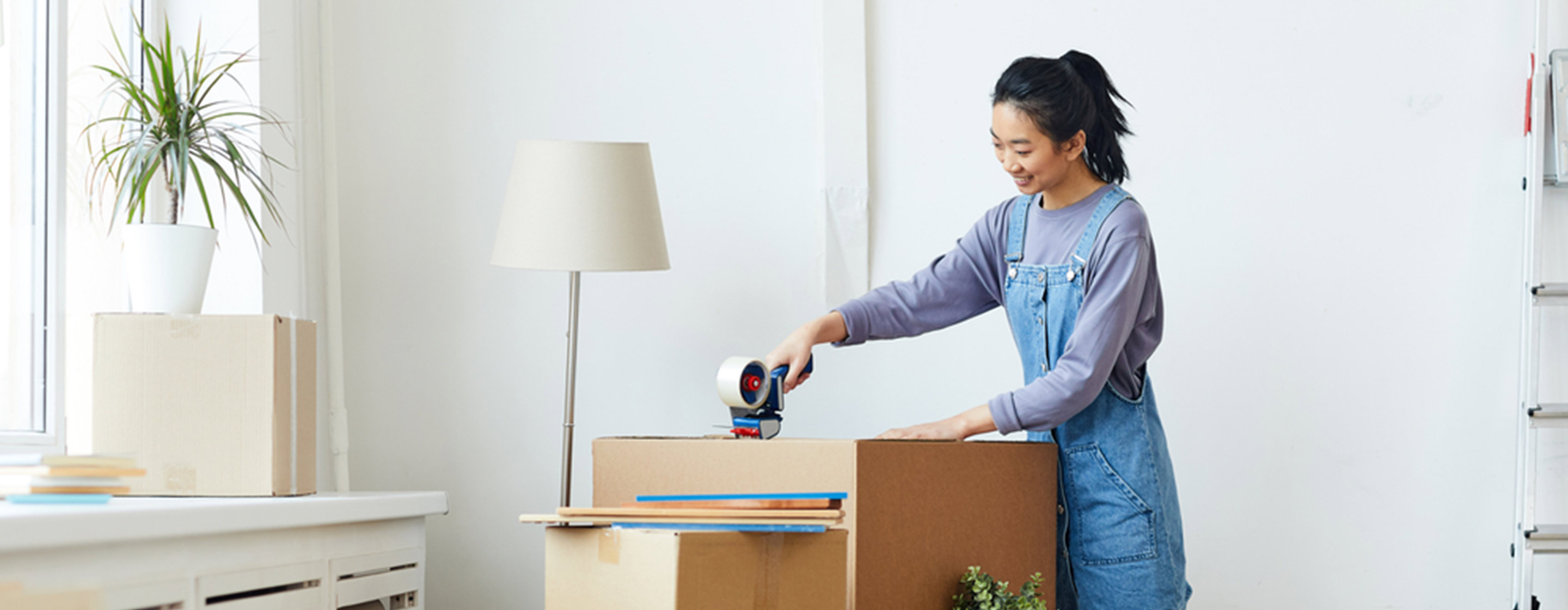 woman packing a cardboard box