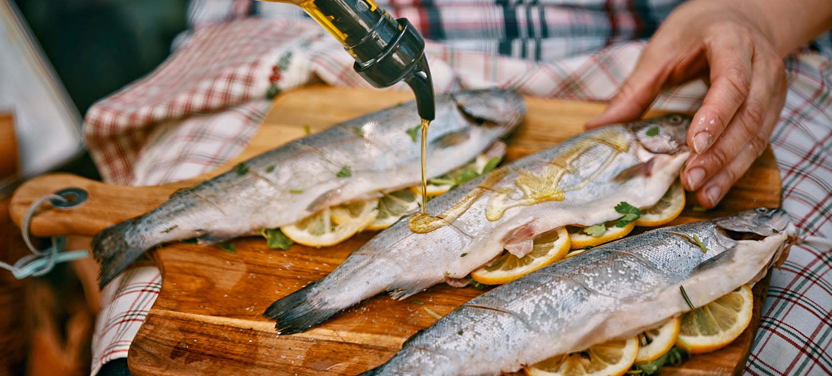 preparing fish with oil and lemons