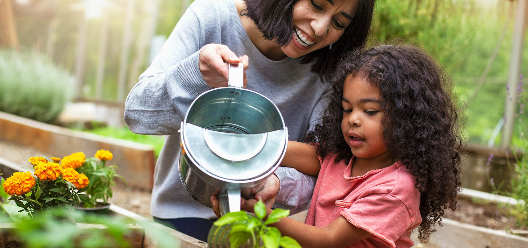 mother and daughter watering plants