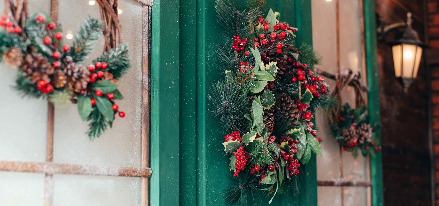 Porch with wooden doors and a threshold with Christmas decor