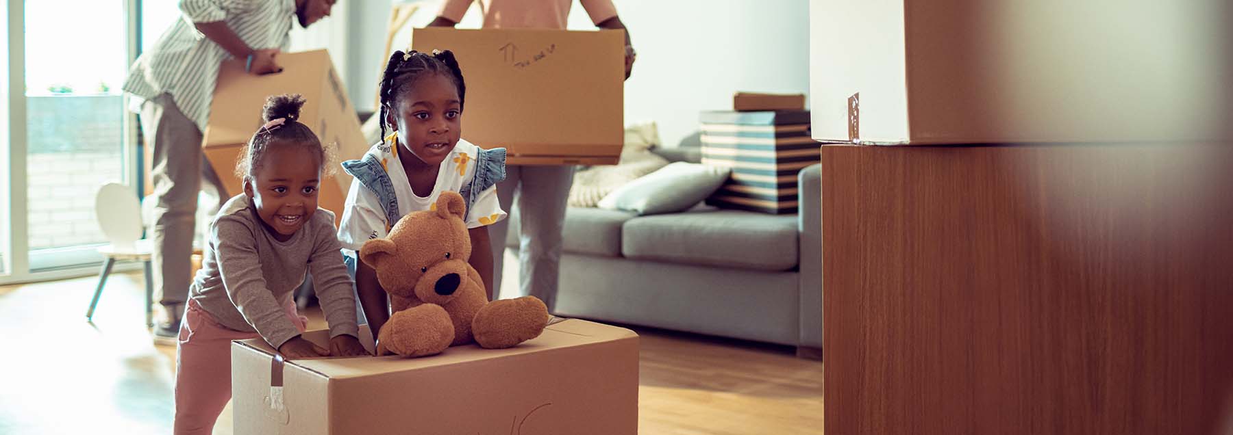  family unpacking their things in their new home