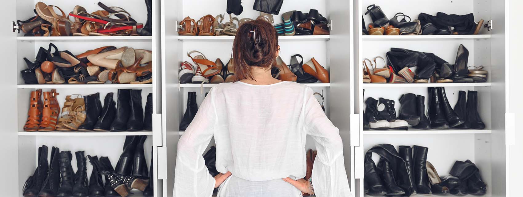 woman standing in front of her messy shoe closet