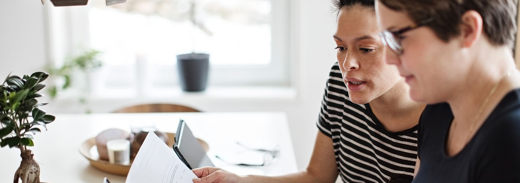  couple discussing over financial bills while using laptop at table