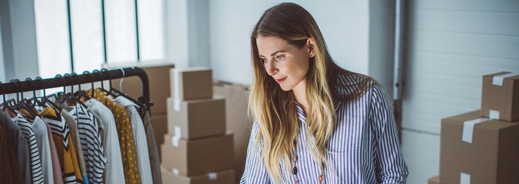 owner of small business packing product in boxes, preparing it for delivery