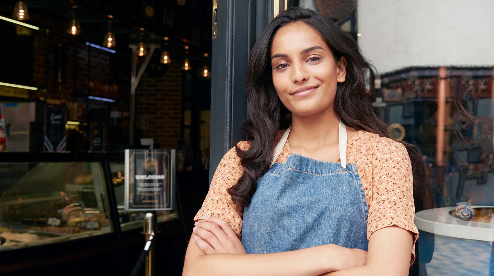 small business owner in front of her shop