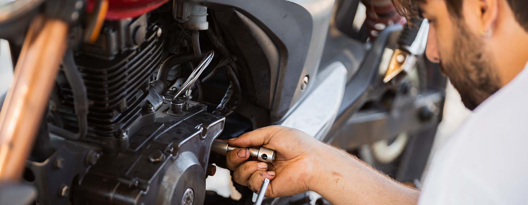 man repairs the coupling on his own motorbike