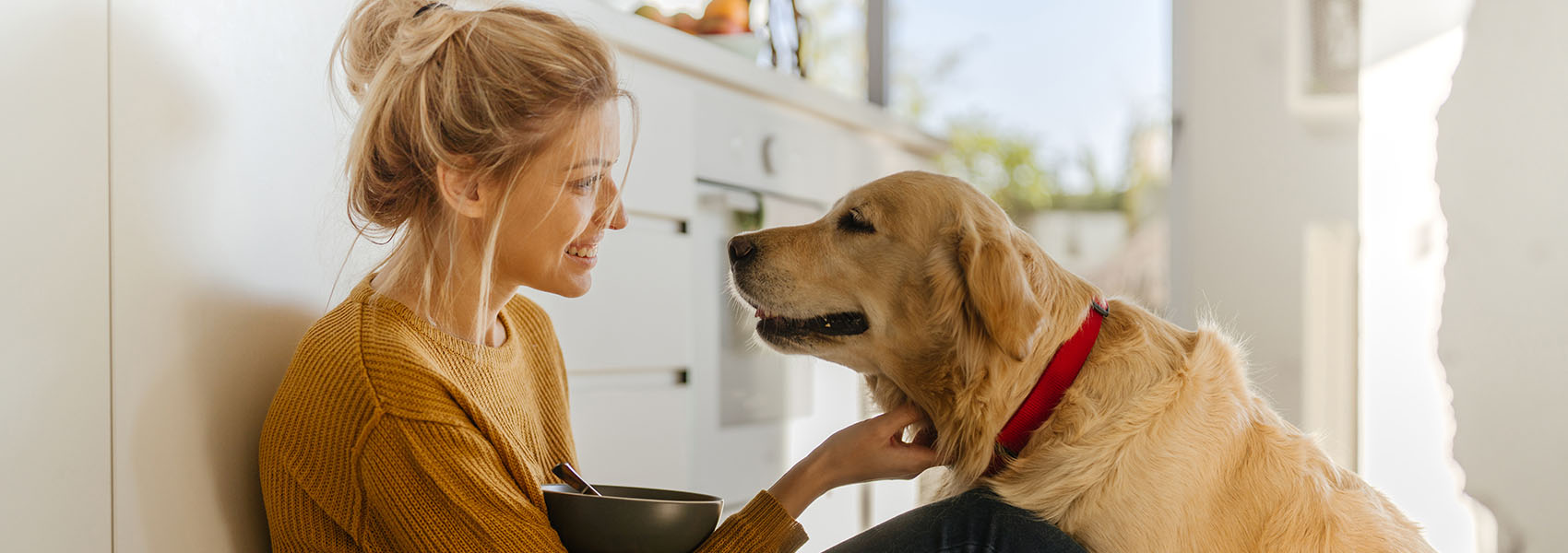 woman and dog in kitchen