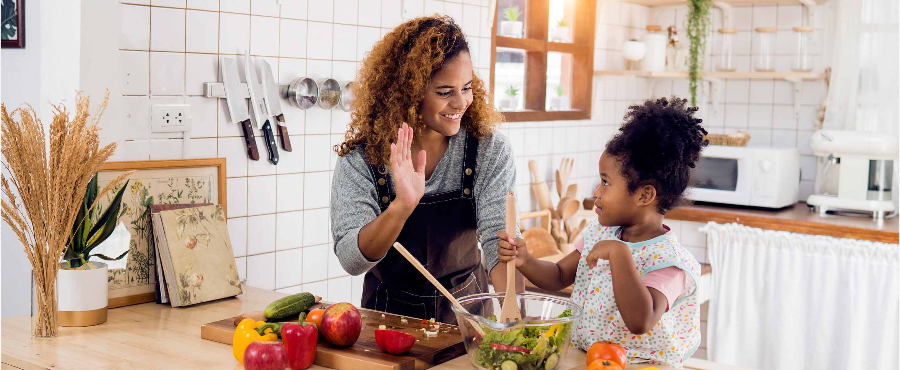 mother and daughter cooking in the kitchen