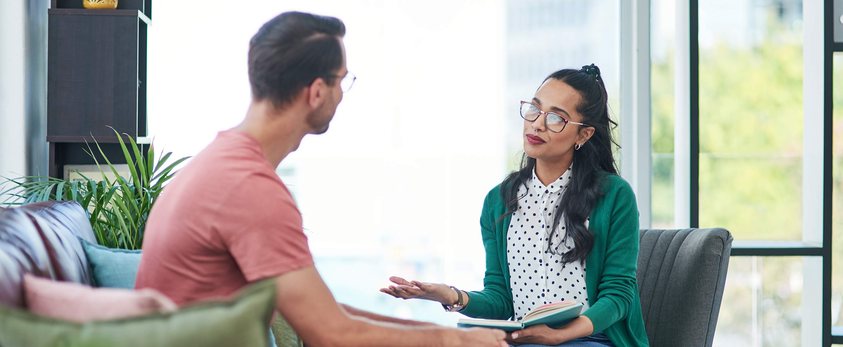 man and woman having a discussion in an office