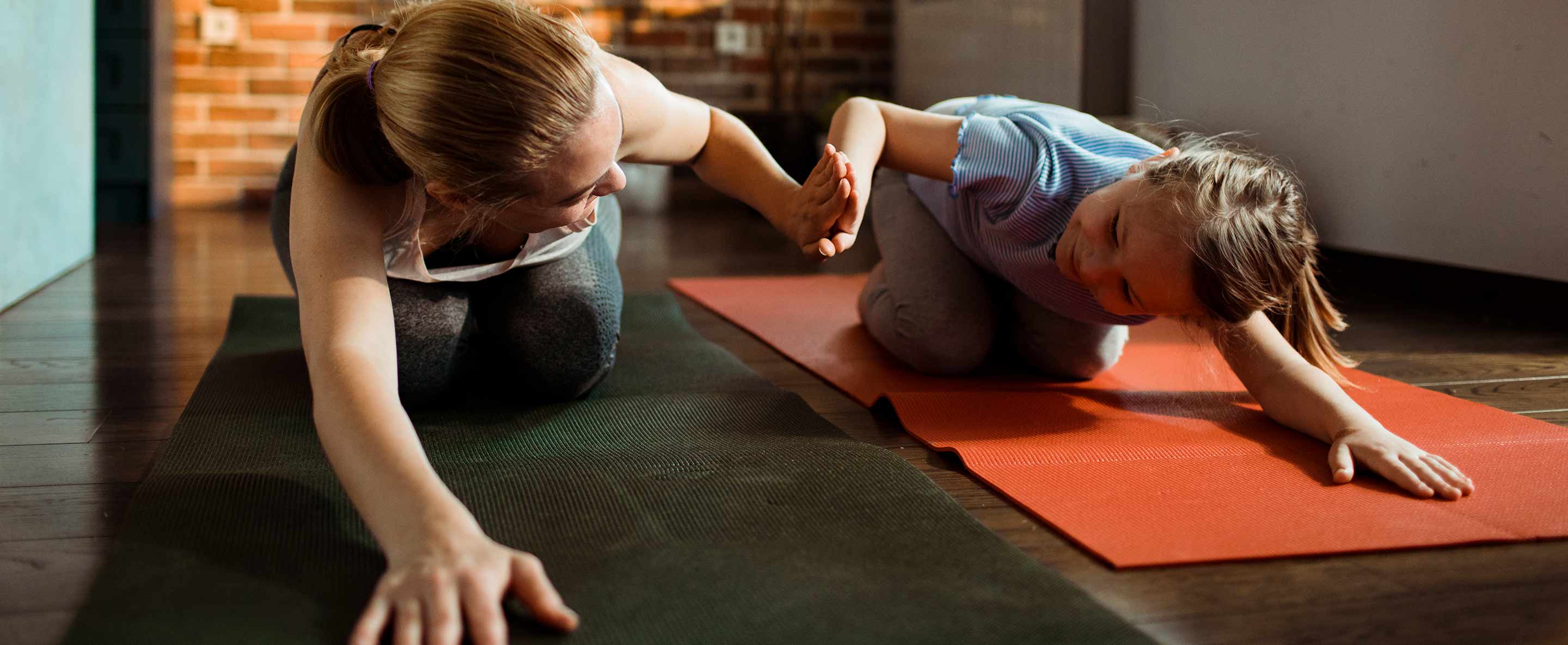 mother and daughter doing yoga together