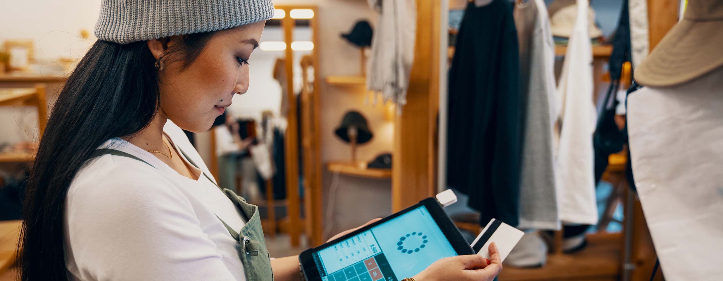 a cashier making a transaction using a tablet