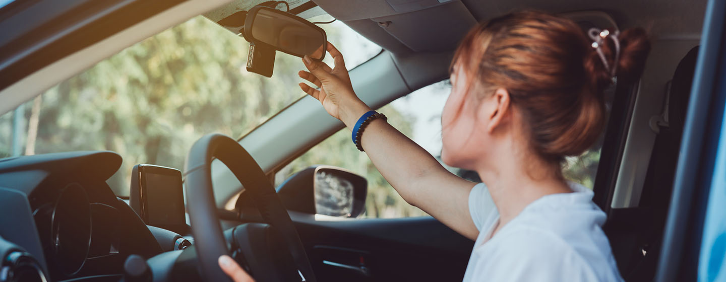 Driver looking at rear view mirror