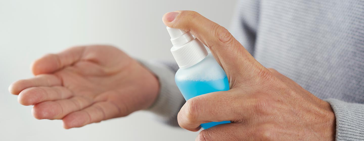 spraying hand sanitizer