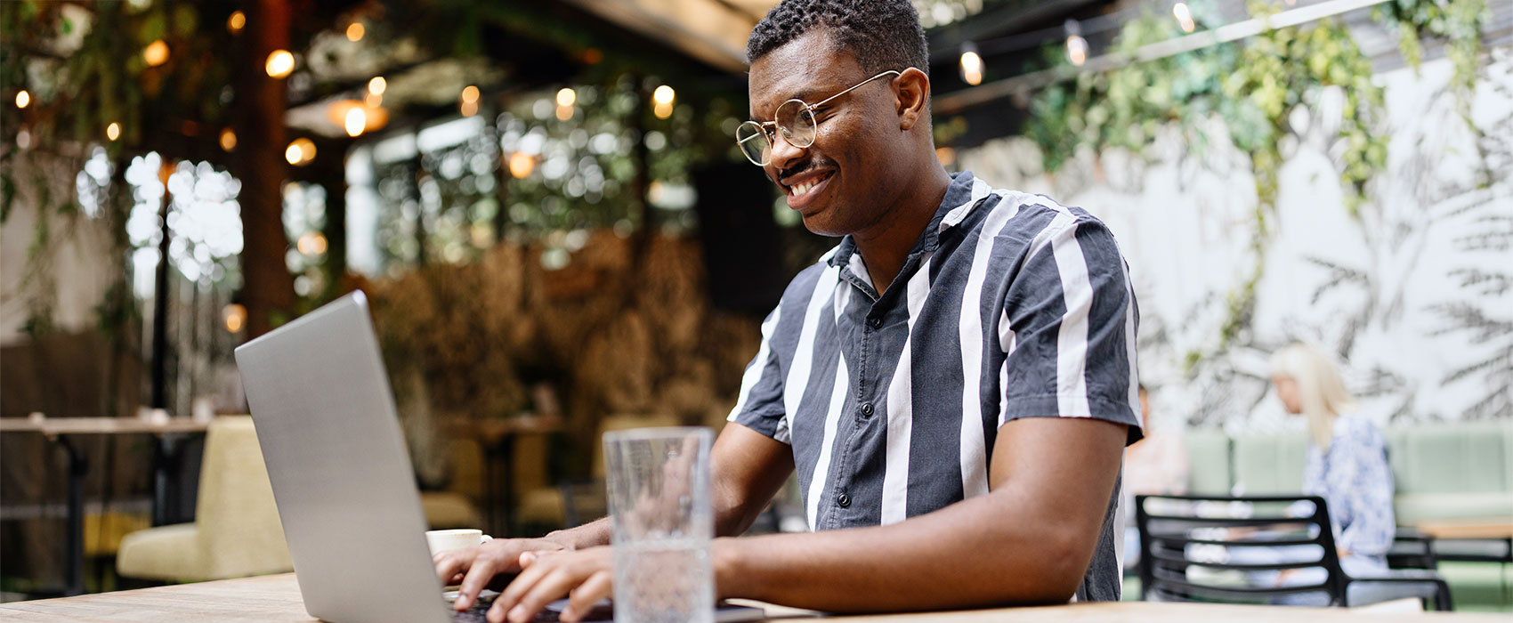 young man working on his laptop at the cafe