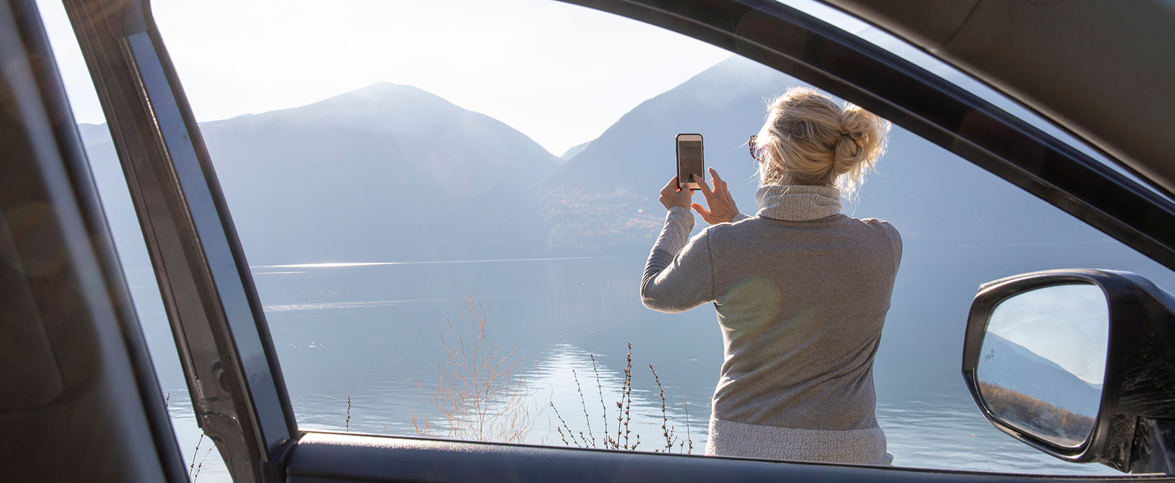 Woman takes a scenic photo from her smart phone