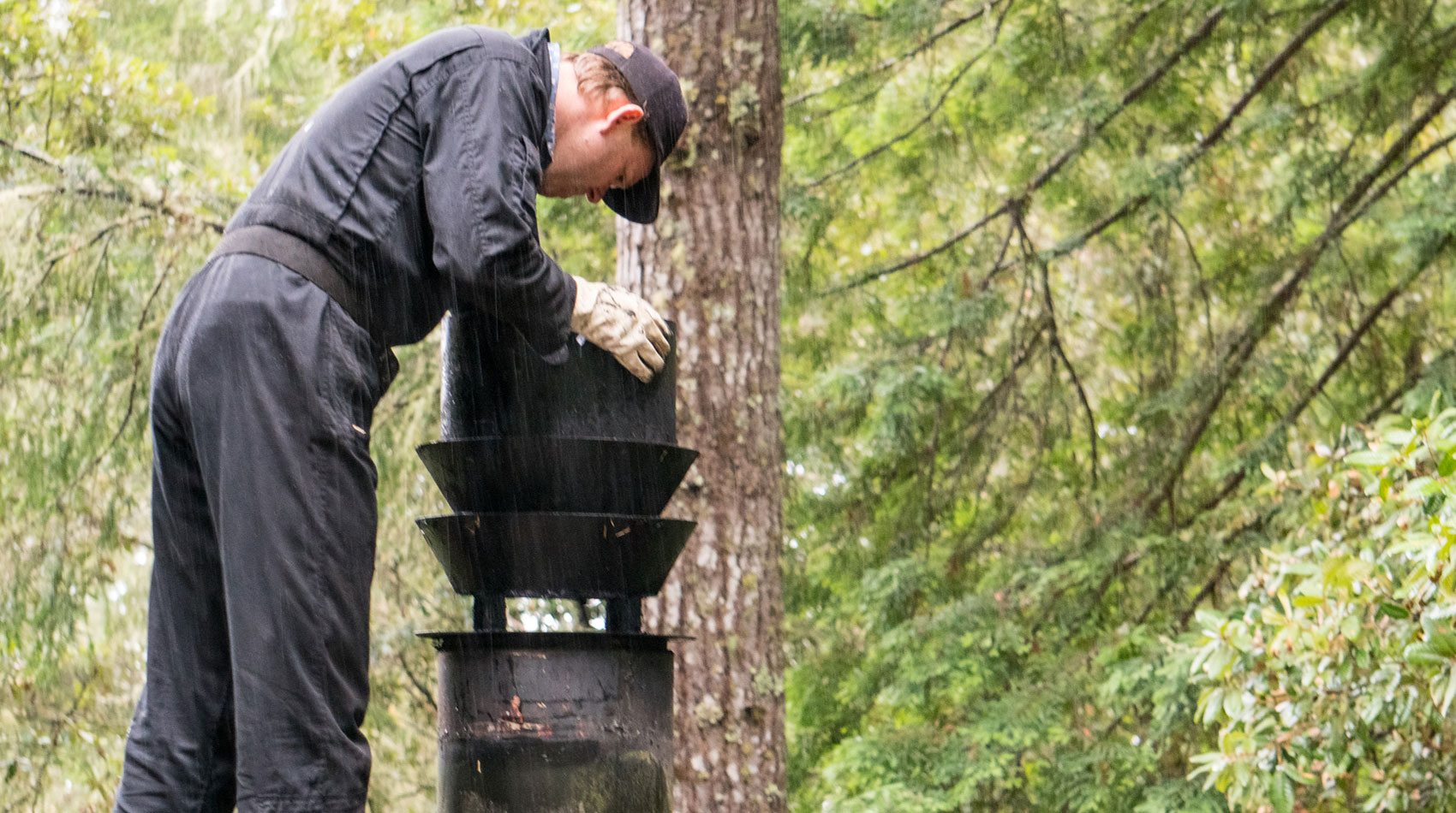 Man examining smoke alarm holding batteries 