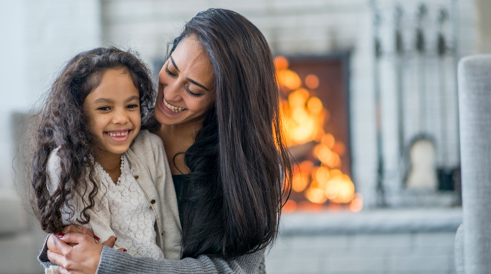 Woman and girl are indoors in their living room