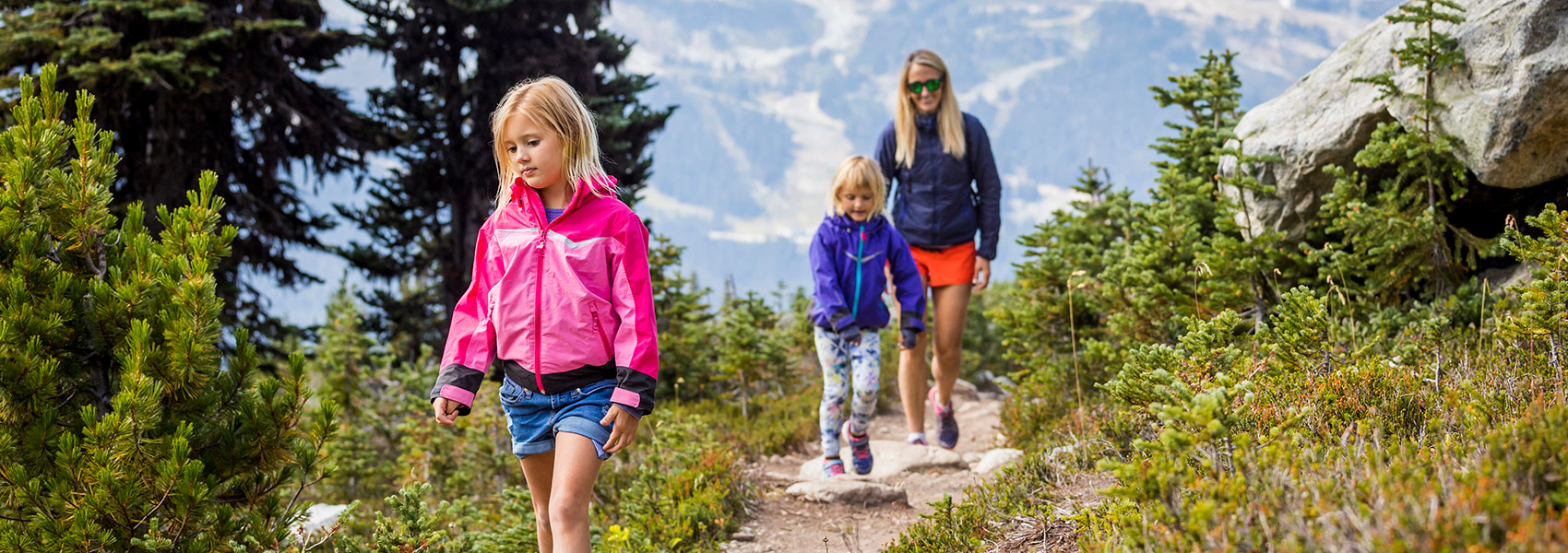 Single mother with daughters hiking on Blackcomb mountain, Whistler, BC