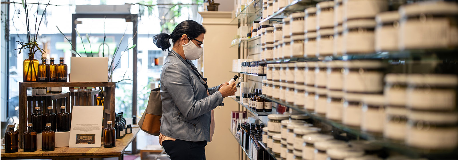 masked woman shopping in store