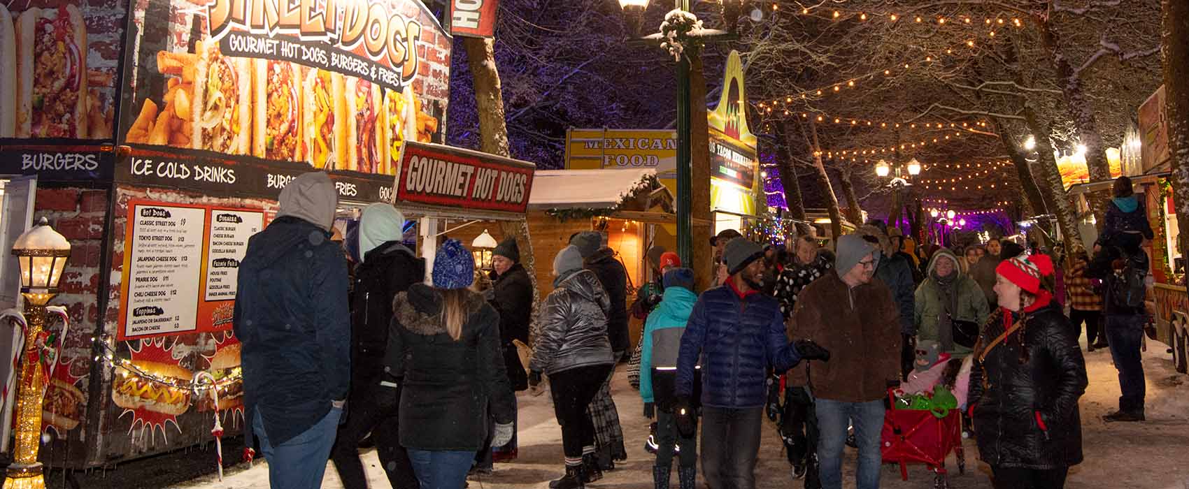 People walking through food trucks outside at PNE Winter Fair