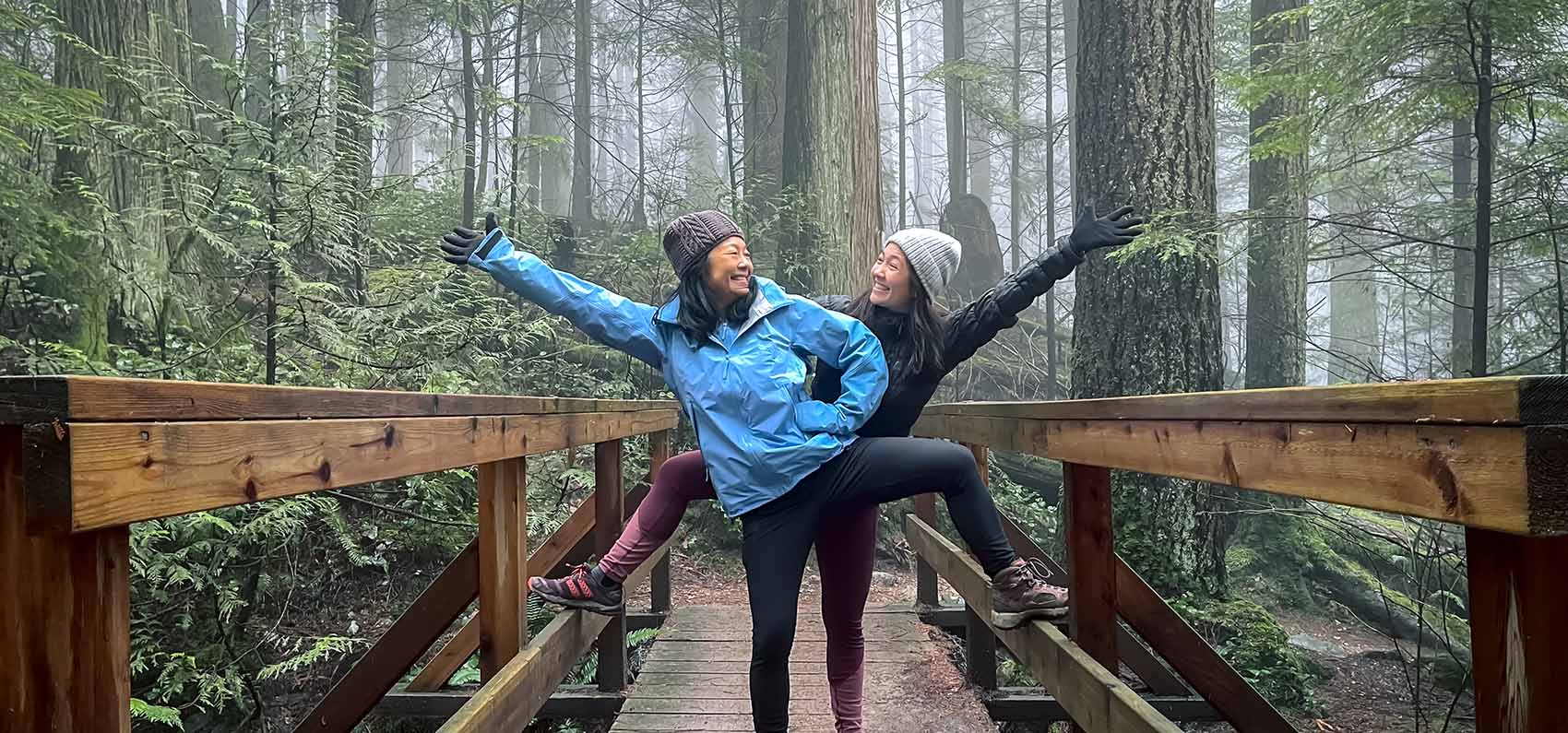 mother and daughter posing on bridge in a forest on Mount Seymour, North Vancouver, British Columbia, Canada