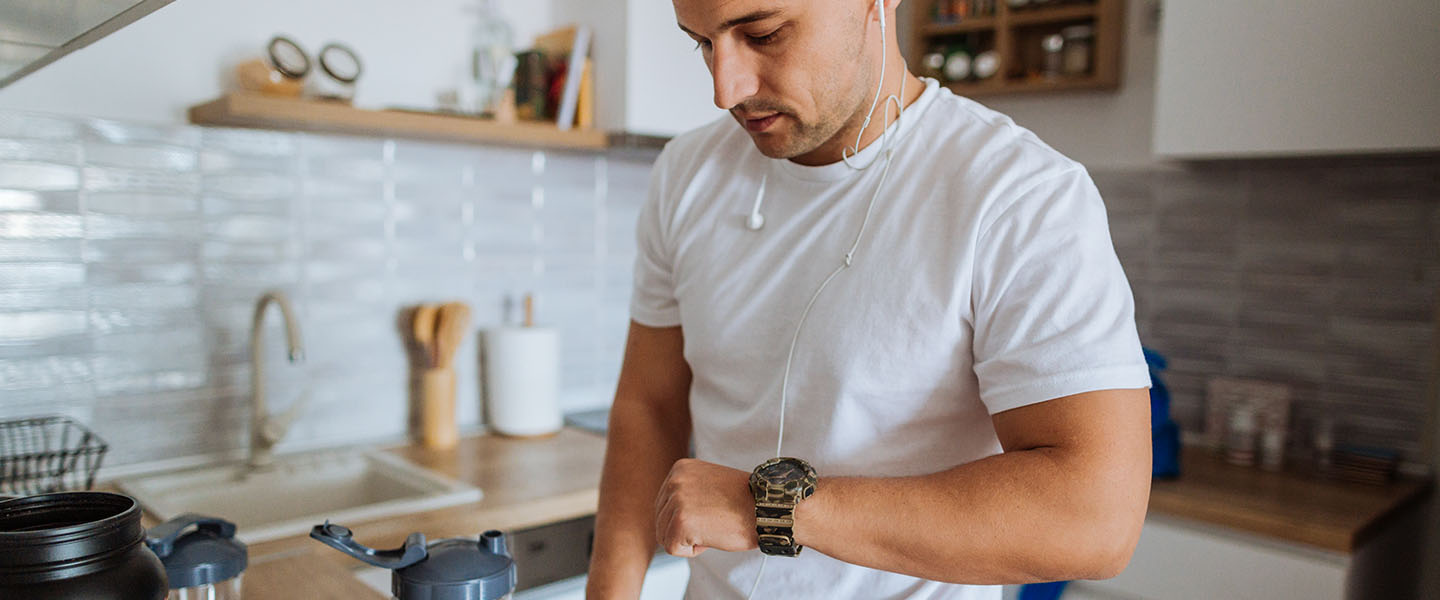 man checking fitness watch