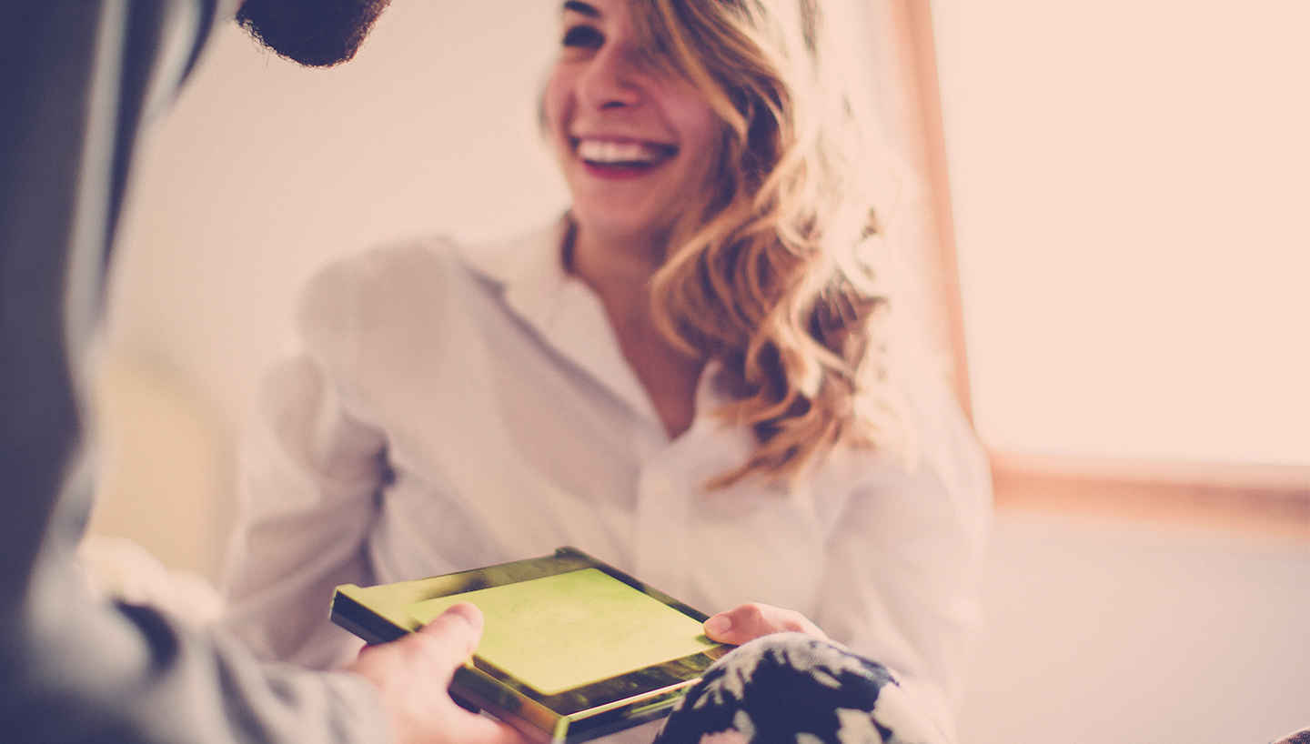 woman receiving gift from man