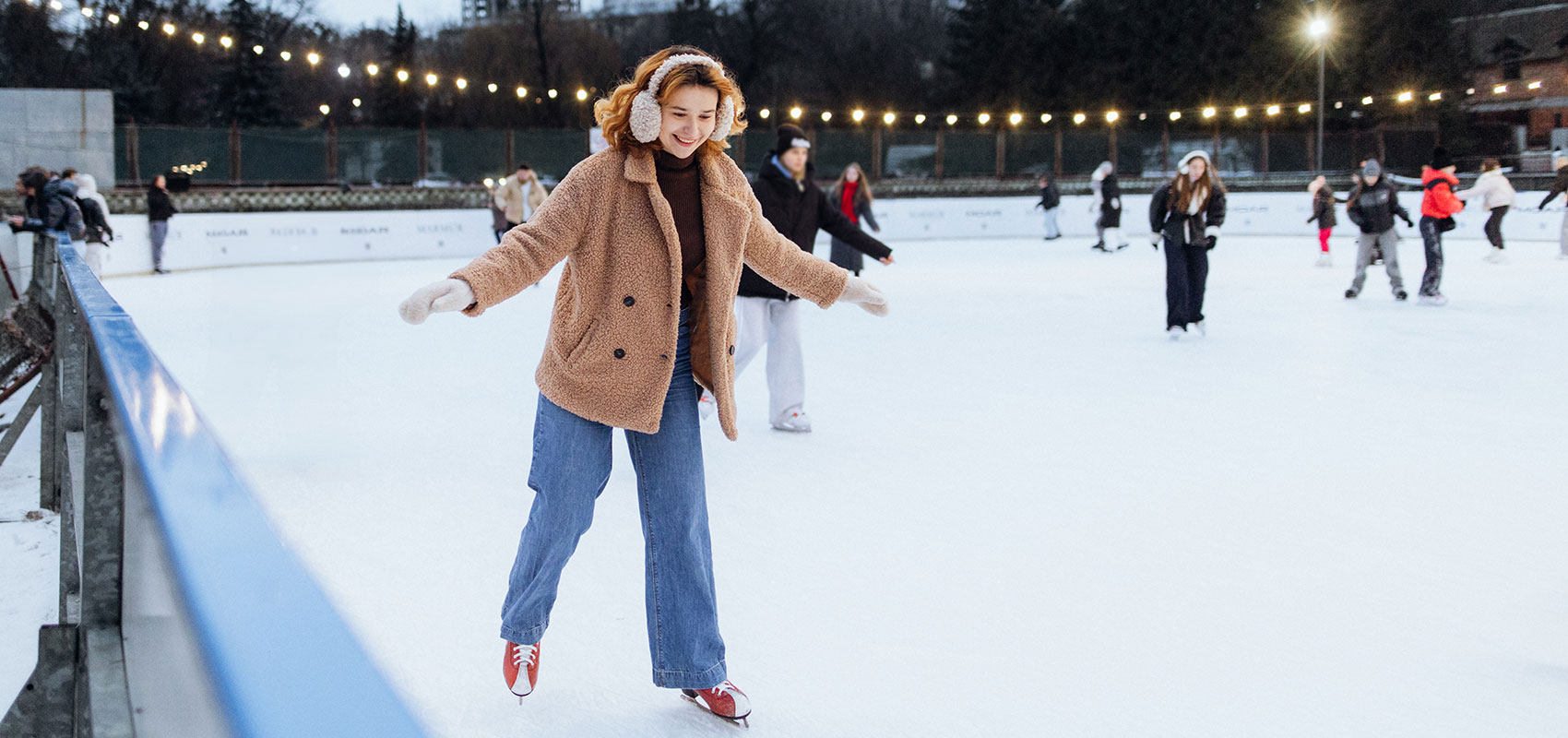 Joyful woman gracefully skating across the ice rink
