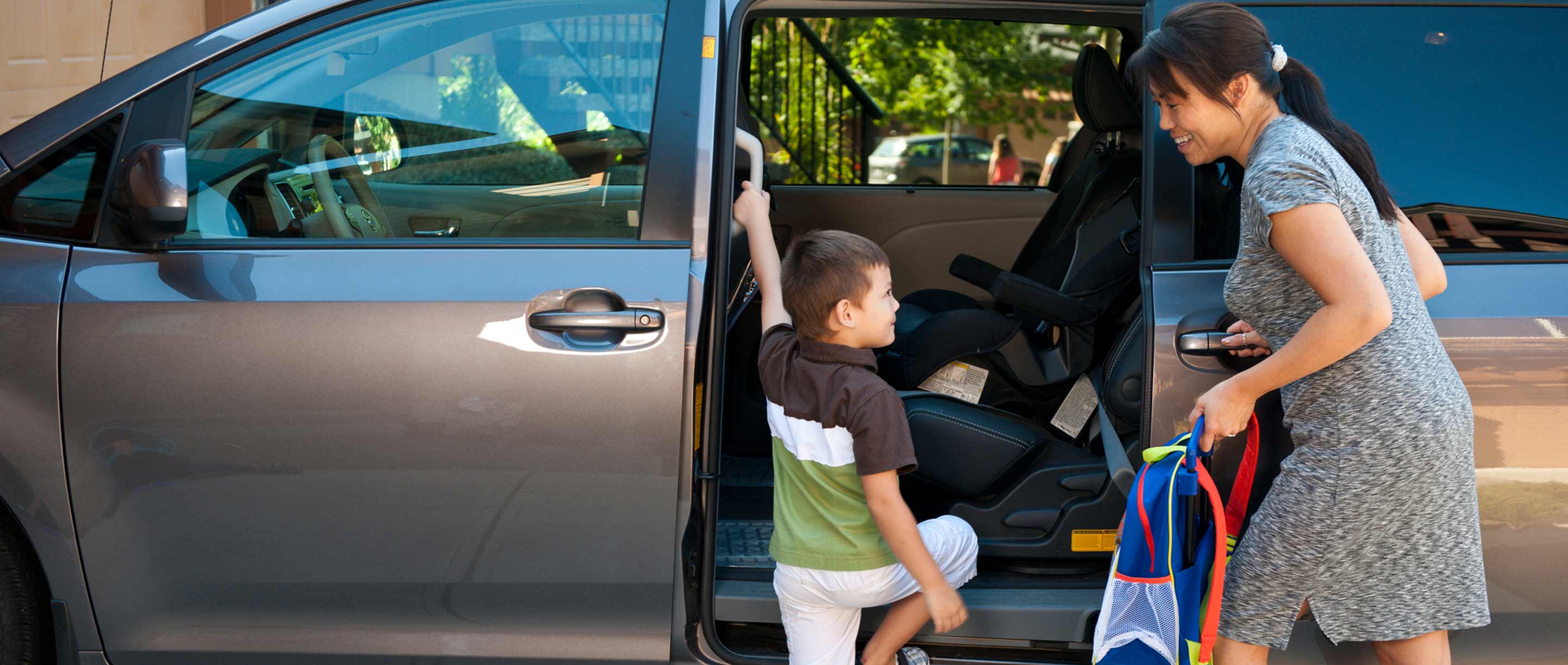 mom and child getting into family van