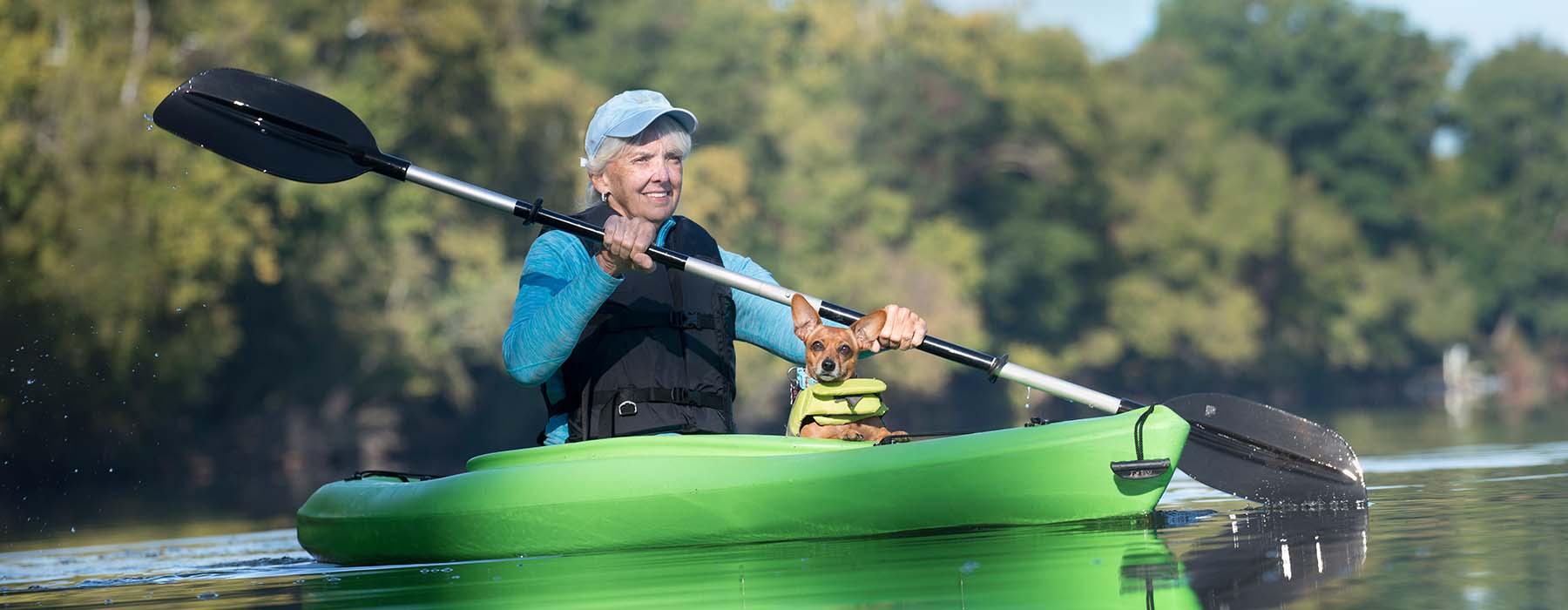 Senior Woman Kayaking with her Dog