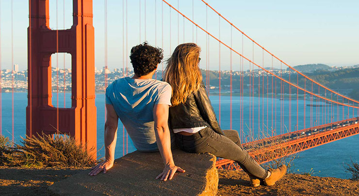 couple admiring Golden Gate Bridge, San Francisco, California, United States