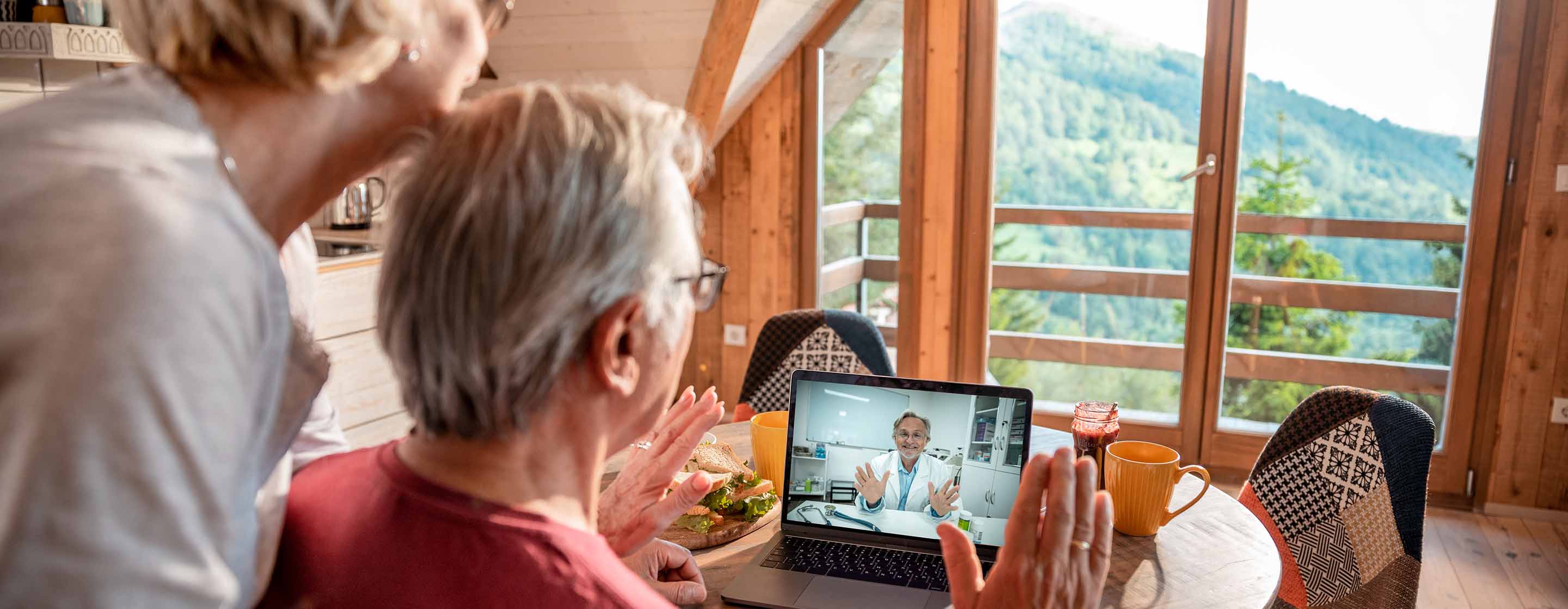 senior couple having a video call with their doctor