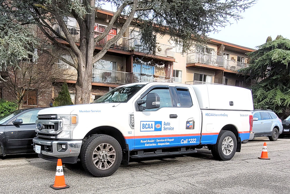 BCAA Saves the Day van parked outside a building with orange cones set up for roadside assistance