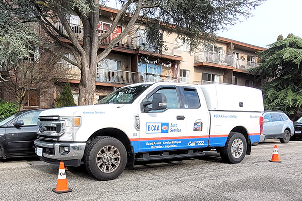 BCAA roadside assistance van parked near a building with orange cones placed around for safety