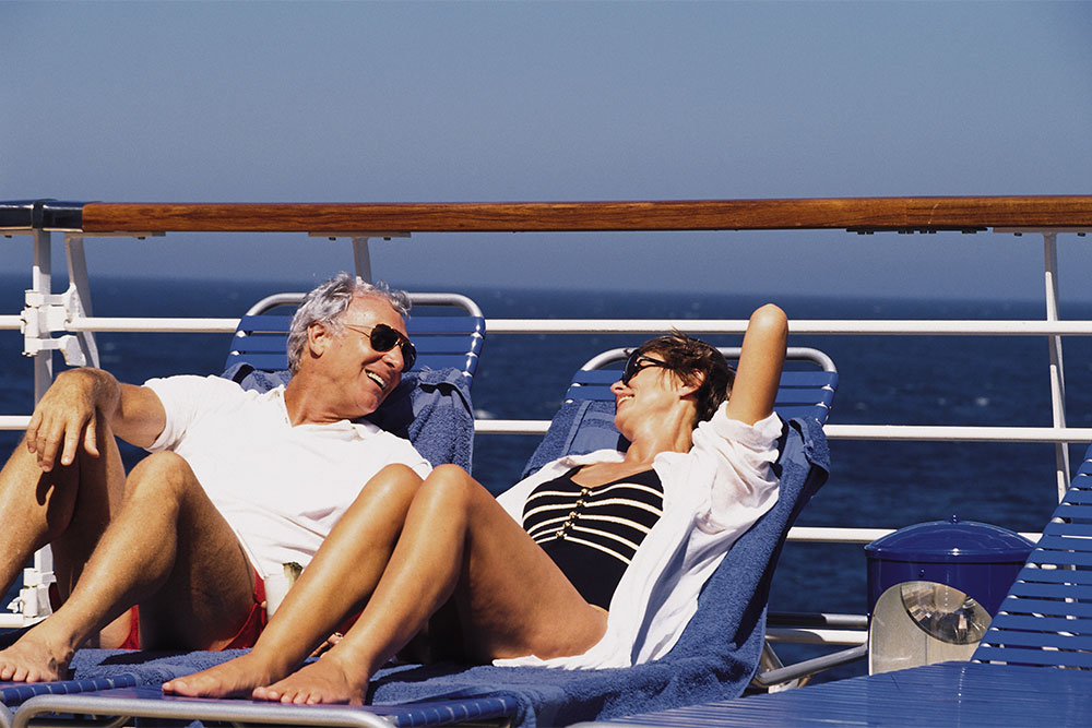 Senior couple relaxing and enjoying the view from the deck of a cruise ship